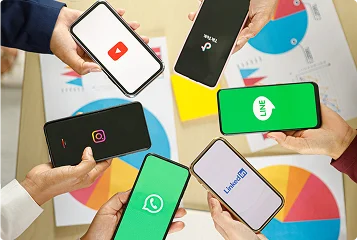 a group of hands holding cell phones