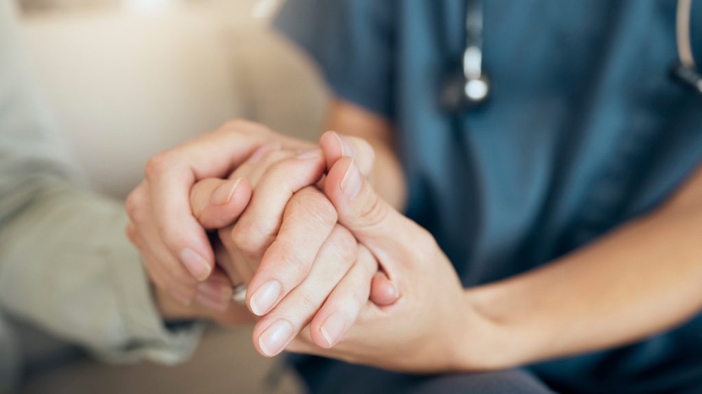 person holding an elderly persons hand