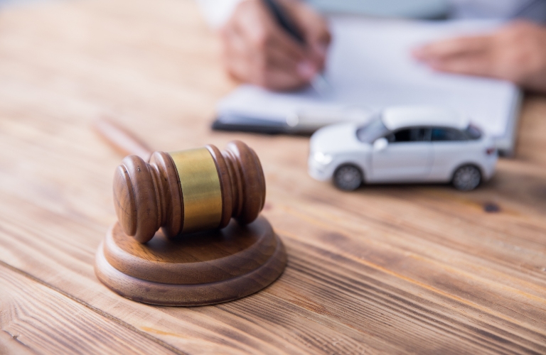 man with judge and car model on desk