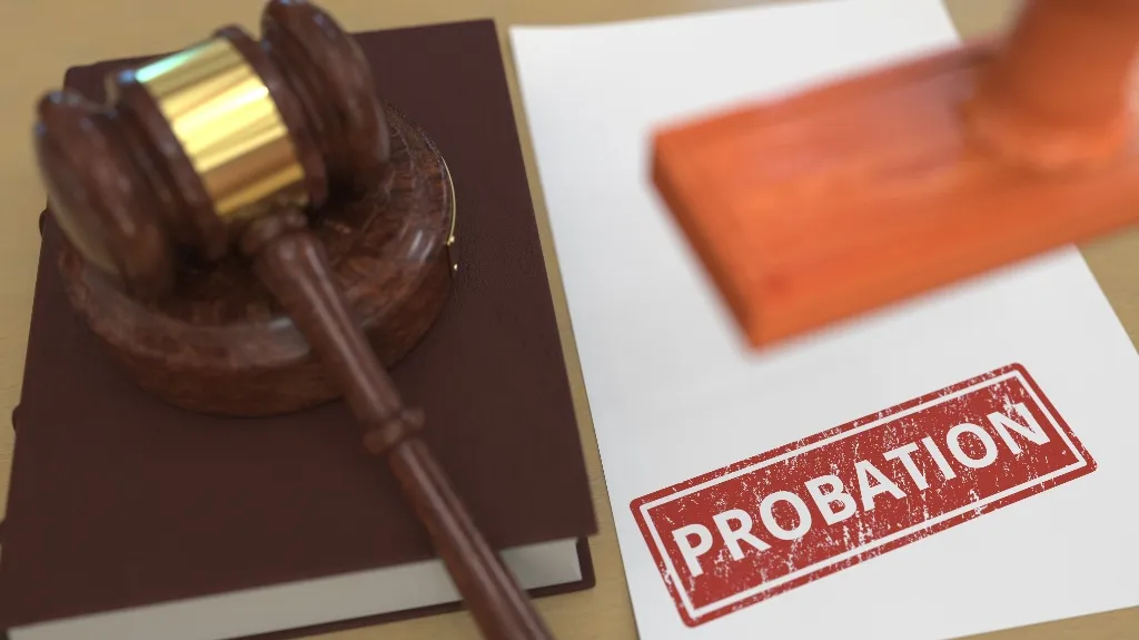 Wooden judge’s gavel on a book beside a document stamped with the word "PROBATION.